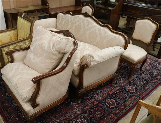 A modern carved mahogany suite on the Louis XV style covered in ivory brocade,